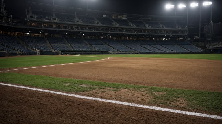 A baseball stadium infield before a night game, empty seats and bright floodlights, chalked baseline, no logos or readable text